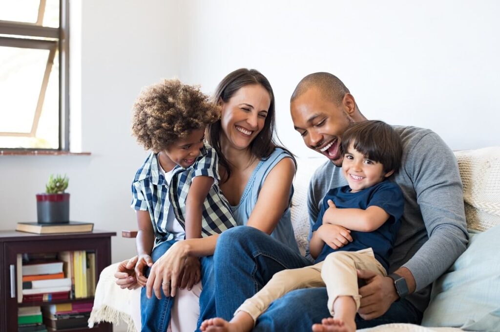 family sat smiling together image